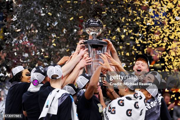 The Purdue Boilermakers celebrate with the trophy after defeating the Penn State Nittany Lions in the Big Ten Basketball Tournament Championship game...