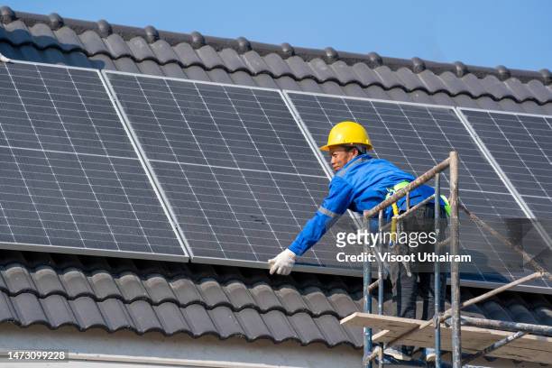 engineer team working on replacement solar panel on roof top of home. - roof replacement stock pictures, royalty-free photos & images