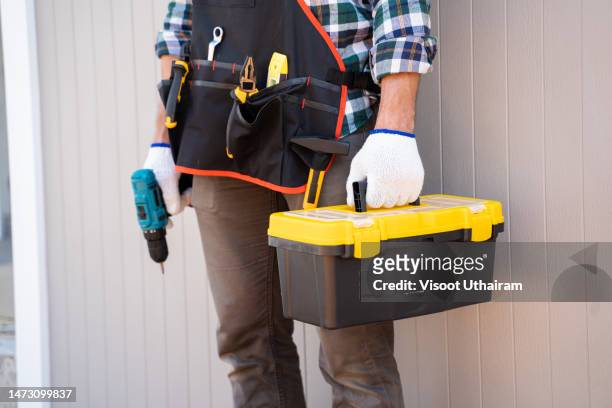builder handyman with drill and construction tools. - handyman stock-fotos und bilder