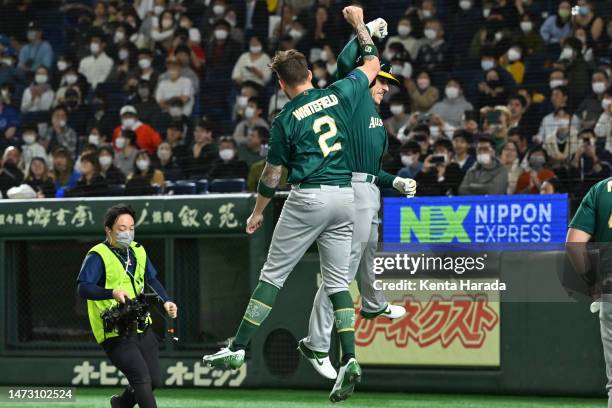 Alex Hall of Australia celebrates with teammate Aaron Whitefield after hitting a solo home run to make it 1-0 in the first inning during the World...