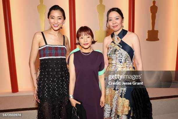 Anne Watanabe, Mipo O, and guest attend the 95th Annual Academy Awards on March 12, 2023 in Hollywood, California.