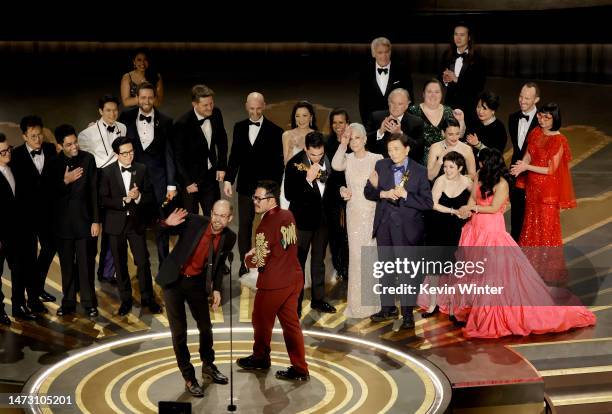 Daniel Scheinert and Daniel Kwan accept the Best Picture award for "Everything Everywhere All at Once" along with cast and crew onstage during the...