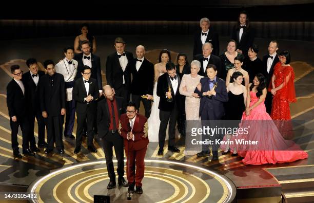 Daniel Scheinert and Daniel Kwan accept the Best Picture award for "Everything Everywhere All at Once" along with cast and crew onstage during the...