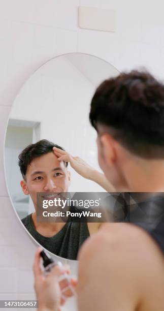 Man Use Hair Growing Tonic High-Res Stock Photo