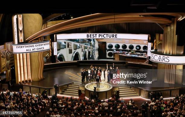 Jonathan Wang accepts the Best Picture award for "Everything Everywhere All at Once" along with cast and crew onstage during the 95th Annual Academy...