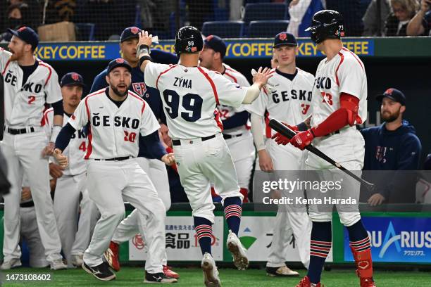 Petr Zyma of the Czech Republic celebrates with teammates after scoring a run to make it 1-1 in the third inning during the World Baseball Classic...