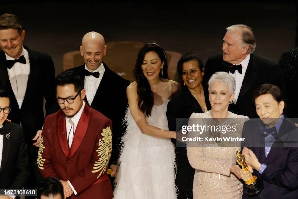 Daniel Kwan, Michelle Yeoh, Jamie Lee Curtis, James Hong, and cast and crew accept the Best Picture award for "Everything Everywhere All at Once"...