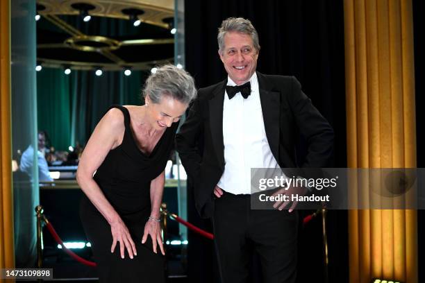 In this handout photo provided by A.M.P.A.S., Andie MacDowell and Hugh Grant are seen backstage during the 95th Annual Academy Awards on March 12,...