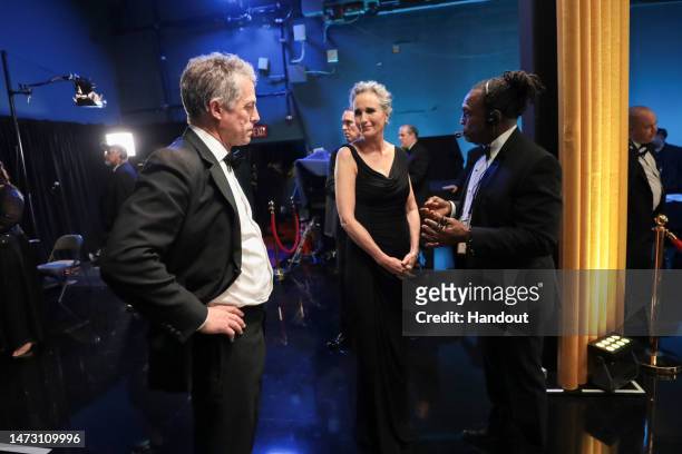 In this handout photo provided by A.M.P.A.S., Hugh Grant and Andie MacDowell are seen backstage during the 95th Annual Academy Awards on March 12,...