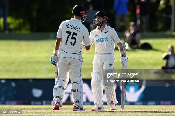 Daryl Mitchell and Kane Williamson of New Zealand shake hands during day five of the First Test match in the series between New Zealand and Sri Lanka...