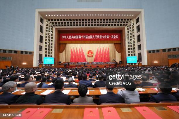 Deputies to the 14th National People's Congress attend the closing meeting of the first session of the 14th National People's Congress at the Great...
