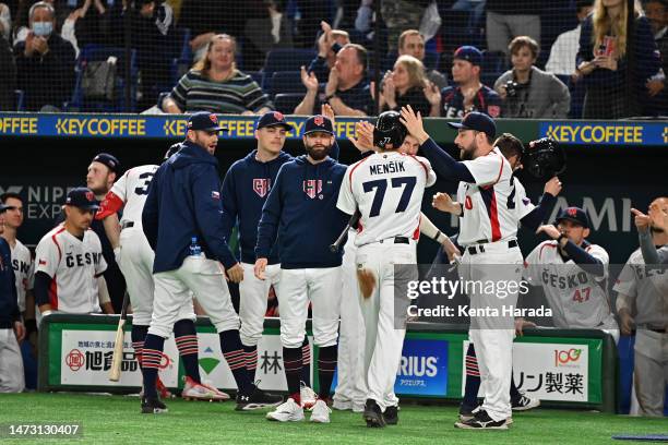 Vojtech Mensik of the Czech Republic celebrates with teammates after scoring a run by a two-run single of Marek Chlup to make it 7-3 in the eighth...