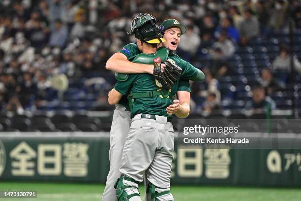 Jon Kennedy and Robbie Perkins of Australia celebrate the team's victory in the World Baseball Classic Pool B game between Australia and Czech...