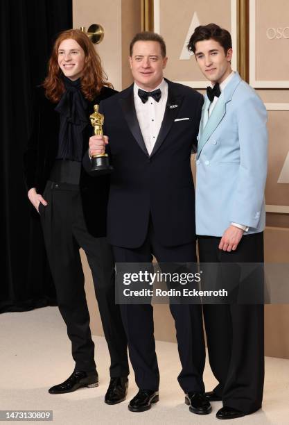 Leland Fraser, Brendan Fraser, winner of the Best Actor in a Leading Role award for "The Whale," and Holden Fraser pose in the press room during the...