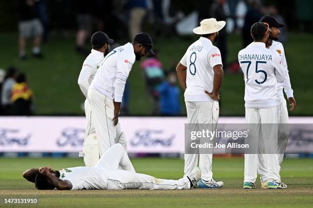 Asitha Fernando of Sri Lanka lays dejected on the ground after losing the First Test match in the series between New Zealand and Sri Lanka at Hagley...