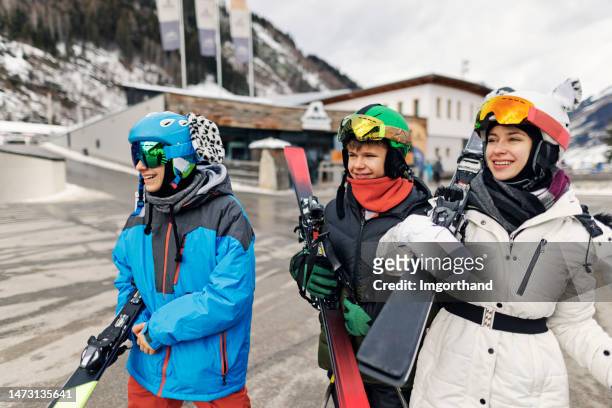 teenagers returning to car after skiing in european alps - apres ski stock pictures, royalty-free photos & images