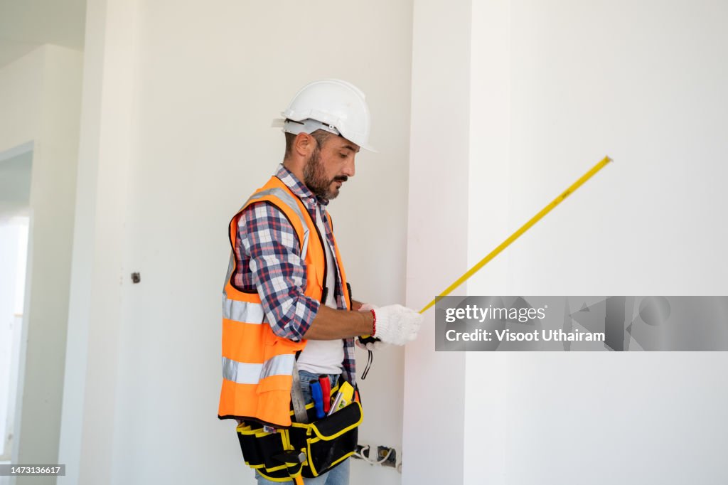 Builders Using Measure Builder Man Use Tape Measure Inspect The Reconstructed To Construction ...