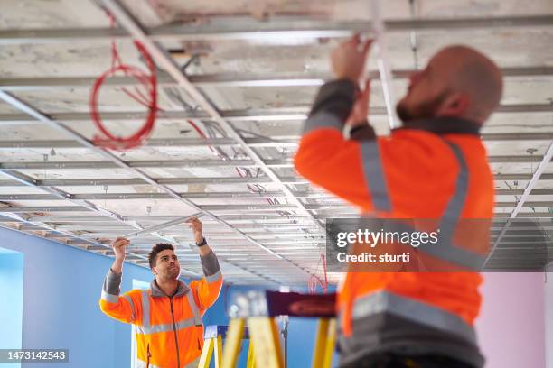 fitting a suspended ceiling - refurbished stock pictures, royalty-free photos & images