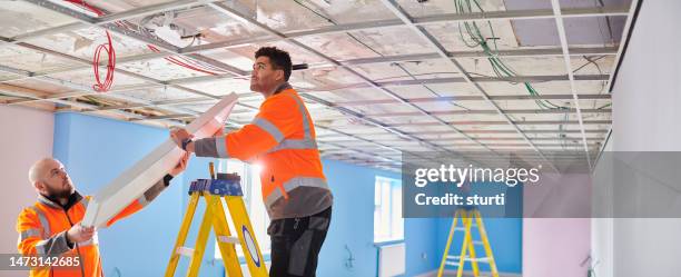 fitting a suspended ceiling light - electrical equipment stock pictures, royalty-free photos & images
