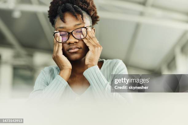 tired african american woman rubbing her eyes. - rubbing eyes stock pictures, royalty-free photos & images