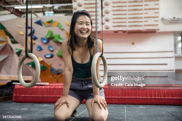 portrait happy female rock climber training in climbing gym - smiley stock pictures, royalty-free photos & images