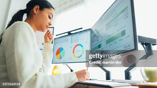Woman with back pain working at standing desk home office Woman with back pain working at standing desk home office