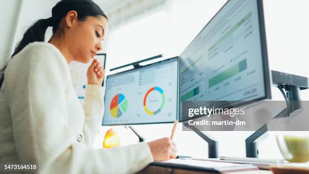 woman with back pain working at standing desk home office - analytics imagens e fotografias de stock