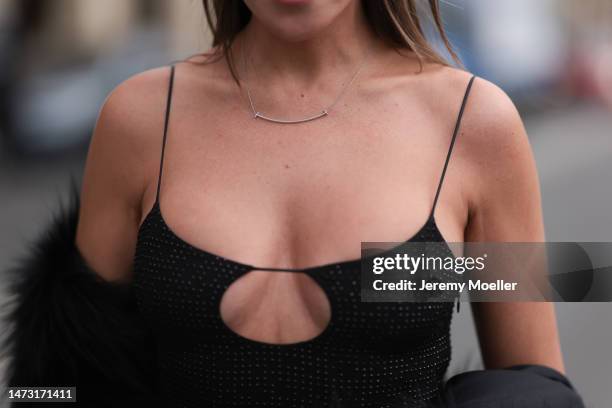 Yasemin Ögün seen wearing black strapless glitter Miu Miu dress, silver Tiffany & Co diamond chain, Salomon fake fur black coat during Paris Fashion...