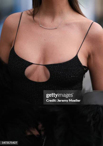 Yasemin Ögün seen wearing black strapless glitter Miu Miu dress, silver Tiffany & Co diamond chain, Salomon fake fur black coat during Paris Fashion...