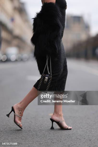 Yasemin Ögün seen wearing black strapless glitter Miu Miu dress, silver Amina Muaddi glitter heels, small black Miu Miu bag with rivet, Salomon fake...
