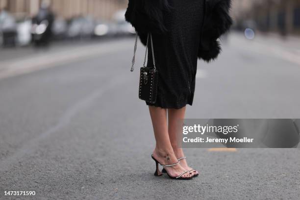 Yasemin Ögün seen wearing black strapless glitter Miu Miu dress, silver Amina Muaddi glitter heels, small black Miu Miu bag with rivet, Salomon fake...