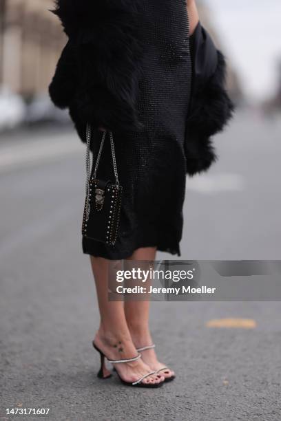 Yasemin Ögün seen wearing black strapless glitter Miu Miu dress, silver Amina Muaddi glitter heels, small black Miu Miu bag with rivet, Salomon fake...