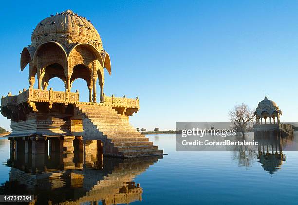 buildings on gadi sagar lake in jaisalmer, rajasthan, india - indian temples stock pictures, royalty-free photos & images