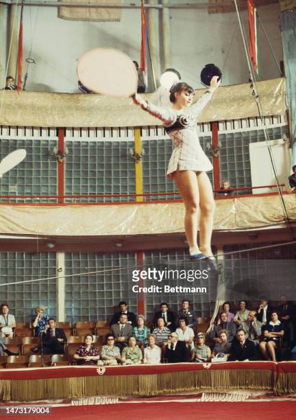 First Lady Pat Nixon attends a tightrope walking performance at the Moscow Circus School in Russia on July 2nd, 1974.