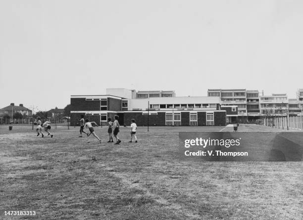 Children play outside Abbey Primary School, part of the new GLC Thamesmead housing development situated between Woolwich and Erith, London, 14th July...