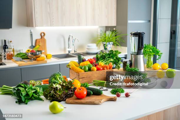 fresh fruits and vegetables on kitchen island - modern kitchen worktop stock pictures, royalty-free photos & images