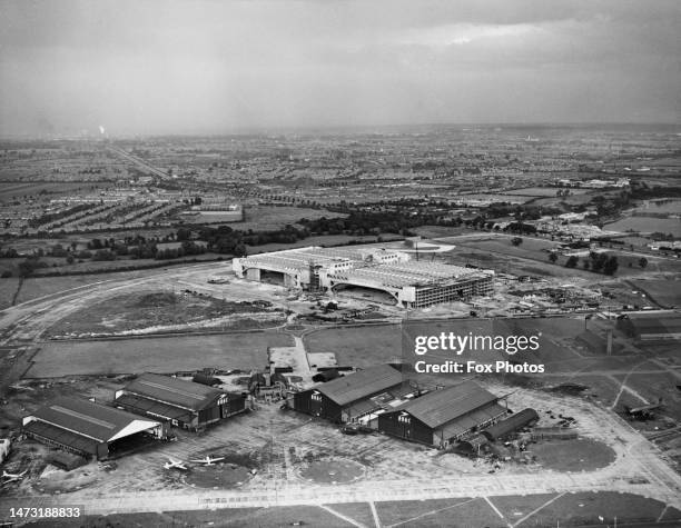 Aerial view of London Airport , BOAC hangars in the foreground with the new concrete aircraft maintenance building being constructed in the...