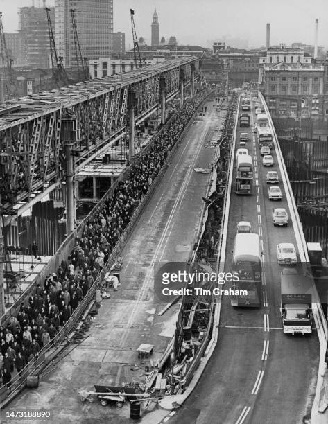 Traffic and commuters cross a section of the partially built new London Bridge in both directions for the first time this morning, London, 23rd...