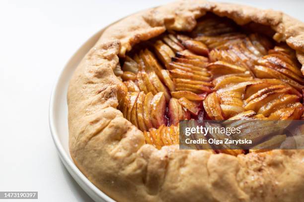 apple galette in white plate. - biscotte stock-fotos und bilder