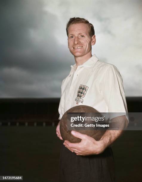 Preston North End and England player Tom Finney pictured holding a ball in his 1953 England shirt.