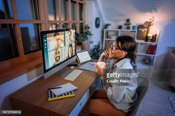 young beautiful smiling businesswoman having video call while working from home office - party board meets stock pictures, royalty-free photos & images