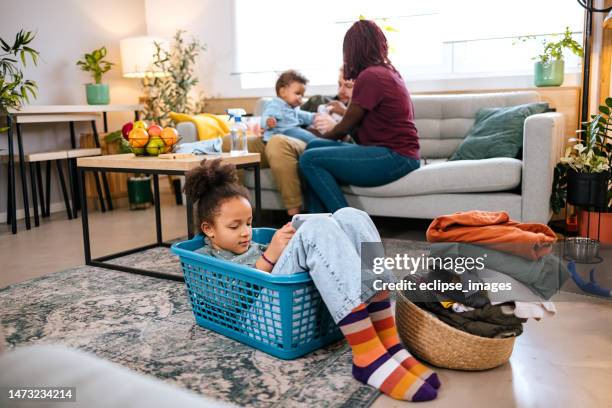 girl in a laundry basket. - man washing basket child stock pictures, royalty-free photos & images