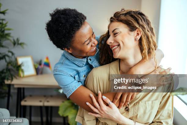 couple embracing at home - milestones stock pictures, royalty-free photos & images