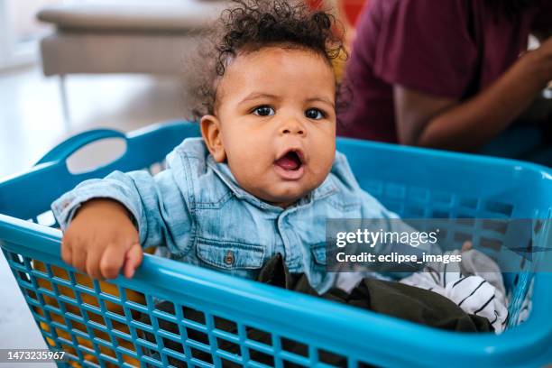 portrait of a little girl in a laundry basket - baby laundry basket bildbanksfoton och bilder