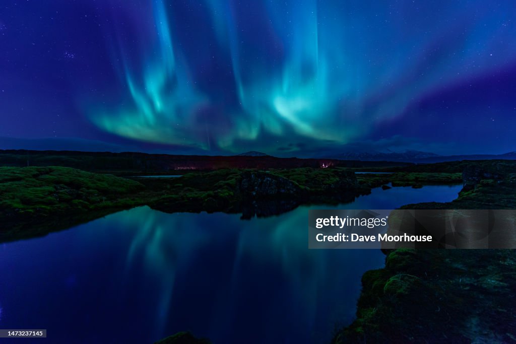 Aurora displaying over the Silfra Rift in Iceland