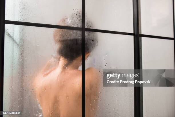 female in cabin shower - rear view hand window stock pictures, royalty-free photos & images