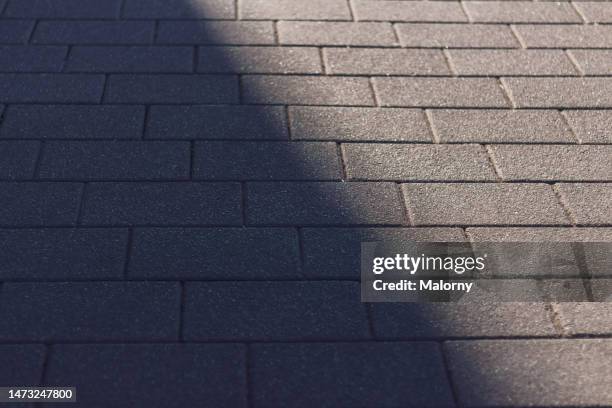 shadow vs sun on the ground. - beton sol stock-fotos und bilder