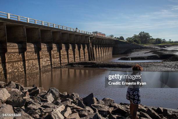 Woman looks at the dam at Canelón Grande reservoir as drought conditions continue on March 13, 2023 in Canelones, Uruguay. Three consecutive years of...