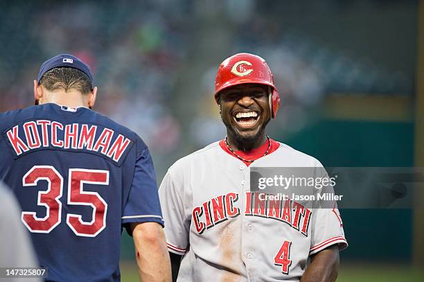 First baseman Casey Kotchman of the Cleveland Indians jokes with Brandon Phillips of the Cincinnati Reds during the sixth inning at Progressive Field...