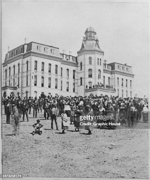 Crowd of Black students on the outside Miner Hall at Howard University, a historically Black university in Washington, DC, circa 1895. The image is...
